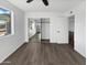 Bedroom featuring wood-look floors and a mirrored closet at 909 W Danbury Rd, Phoenix, AZ 85023