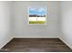 This bedroom featuring vinyl floors, and a large window showcasing the backyard at 909 W Danbury Rd, Phoenix, AZ 85023