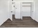 Bedroom featuring wood-look floors and open closet at 909 W Danbury Rd, Phoenix, AZ 85023