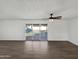 Living room area featuring wood-look floors and a sliding glass door to the backyard swimming pool at 909 W Danbury Rd, Phoenix, AZ 85023