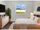 Bright main bedroom featuring vinyl floors, and a large window showcasing the backyard at 909 W Danbury Rd, Phoenix, AZ 85023