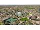 Expansive aerial view showcasing the community's pool, tennis courts, and lush green landscaping at 9266 E Desert Village Dr, Scottsdale, AZ 85255