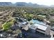 Stunning aerial view of community buildings, pool and green spaces with mountain backdrop at 9266 E Desert Village Dr, Scottsdale, AZ 85255