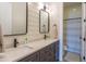 Modern bathroom featuring a dual sink vanity with stylish fixtures and a separate shower area at 9266 E Desert Village Dr, Scottsdale, AZ 85255