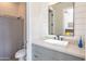 bathroom featuring a modern vanity, bright lighting, and a shower with gray striped curtain at 9266 E Desert Village Dr, Scottsdale, AZ 85255