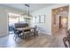 Inviting dining area with modern lighting, wood floors, and sliding doors to the outdoors at 9266 E Desert Village Dr, Scottsdale, AZ 85255