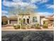 Charming single-story stucco home featuring manicured landscaping, tiled roof and a delightful arched entry at 9266 E Desert Village Dr, Scottsdale, AZ 85255