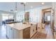 Well-lit kitchen featuring a large island with quartz countertop and stainless steel appliances at 9266 E Desert Village Dr, Scottsdale, AZ 85255