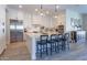 Open kitchen featuring white cabinets, stainless steel appliances and an island with bar stool seating at 9266 E Desert Village Dr, Scottsdale, AZ 85255