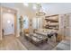 Bright living room featuring high ceilings, a modern chandelier, wood floors and ample natural light at 9266 E Desert Village Dr, Scottsdale, AZ 85255