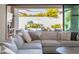 Relaxing living room with large sectional sofa and view of the outdoor pool area at 9266 E Desert Village Dr, Scottsdale, AZ 85255