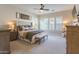 Bright main bedroom with carpeted floors, shutters on the windows, and neutral walls at 9266 E Desert Village Dr, Scottsdale, AZ 85255