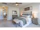 Comfortable carpeted main bedroom with a king bed, ceiling fan and a glimpse of the ensuite at 9266 E Desert Village Dr, Scottsdale, AZ 85255