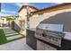 Outdoor kitchen area with a built-in grill, ideal for barbecues and entertaining in the backyard at 9266 E Desert Village Dr, Scottsdale, AZ 85255