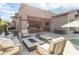 Spacious outdoor patio featuring a fire pit, lounge seating, and a glimpse of the pool, ideal for gatherings at 9266 E Desert Village Dr, Scottsdale, AZ 85255