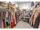 Well-organized walk-in closet with ample storage for shoes, clothes, and accessories at 9266 E Desert Village Dr, Scottsdale, AZ 85255