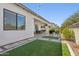 Green artificial turf in an outdoor patio with stone and gravel accents at 942 E Paseo Way, Phoenix, AZ 85042