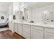 Bathroom featuring hardwood floors, a double vanity, and bedroom access at 942 E Paseo Way, Phoenix, AZ 85042