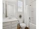 Clean bathroom featuring a modern vanity, toilet, bathtub and a window with shutters at 942 E Paseo Way, Phoenix, AZ 85042