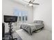 Bedroom featuring a stationary bike, shuttered window and ceiling fan at 942 E Paseo Way, Phoenix, AZ 85042