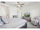 Bright bedroom featuring a ceiling fan, dresser and serene golf course views on TV at 942 E Paseo Way, Phoenix, AZ 85042