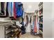 Walk-in closet offering ample storage with built-in shelving and hanging racks at 942 E Paseo Way, Phoenix, AZ 85042