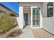 Inviting home entrance featuring a modern door, decorative window and desert landscaping at 942 E Paseo Way, Phoenix, AZ 85042