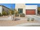 Beautiful contemporary home with a wood-look garage door and desert landscaping at 942 E Paseo Way, Phoenix, AZ 85042