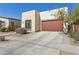 Modern home with a desert landscaped front yard and a spacious concrete driveway at 942 E Paseo Way, Phoenix, AZ 85042