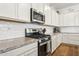 Close up of kitchen with granite countertops, subway tile backsplash, and stainless appliances at 942 E Paseo Way, Phoenix, AZ 85042