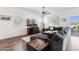 Bright living room features hardwood flooring, large windows, and a modern ceiling fan at 942 E Paseo Way, Phoenix, AZ 85042