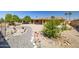 Landscaped backyard with patio, gravel, garden, and orange trees at 9513 W Cottonwood Dr, Sun City, AZ 85373