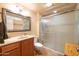 Bathroom with framed mirror, sink with storage and enclosed glass shower at 9513 W Cottonwood Dr, Sun City, AZ 85373