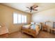 Bright bedroom with a ceiling fan and window with white shutters at 9513 W Cottonwood Dr, Sun City, AZ 85373