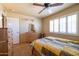 Comfortable bedroom features a ceiling fan, natural light, and neutral tones at 9513 W Cottonwood Dr, Sun City, AZ 85373