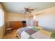 Bedroom features a bed, dresser, ceiling fan, and neutral walls at 9513 W Cottonwood Dr, Sun City, AZ 85373