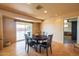 Dining area with a dark wood table set and sliding door access to backyard at 9513 W Cottonwood Dr, Sun City, AZ 85373