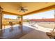 Spacious covered patio area with seating, perfect for relaxing and enjoying the outdoors at 9513 W Cottonwood Dr, Sun City, AZ 85373