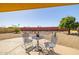 Cozy outdoor patio area featuring a metal table and chairs, perfect for enjoying your morning coffee at 9513 W Cottonwood Dr, Sun City, AZ 85373