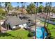 Aerial view of a backyard with a sparkling pool, patio seating, and a well-maintained lawn at 10052 N 77Th St, Scottsdale, AZ 85258