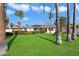 Lush backyard with mature trees, a playset, and plenty of green space at 10052 N 77Th St, Scottsdale, AZ 85258