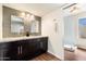 Bathroom showcasing a double vanity with granite countertop and modern shower at 10052 N 77Th St, Scottsdale, AZ 85258
