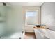 Modern bathroom with a soaking tub, frosted glass shower, and stylish wood-look flooring at 10052 N 77Th St, Scottsdale, AZ 85258