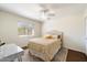 Cozy bedroom with a ceiling fan, natural light, and a neutral color scheme at 10052 N 77Th St, Scottsdale, AZ 85258