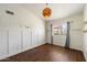 Bright bedroom with wainscoting, patterned wallpaper, and modern light fixture at 10052 N 77Th St, Scottsdale, AZ 85258