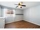 Clean bedroom with a ceiling fan, wood-look floors, and abundant natural light at 10052 N 77Th St, Scottsdale, AZ 85258