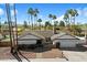 Charming single-story home featuring a brick chimney, two-car garage, beautiful desert landscaping and many palm trees at 10052 N 77Th St, Scottsdale, AZ 85258