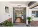 Inviting front entrance featuring double doors, brick accents, and a glimpse into the home's bright interior at 10052 N 77Th St, Scottsdale, AZ 85258