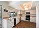 This kitchen has stainless steel appliances, white cabinetry, and a view of the pool at 10052 N 77Th St, Scottsdale, AZ 85258
