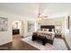 Cozy main bedroom with a sitting area, ensuite bath, and ceiling fan at 10052 N 77Th St, Scottsdale, AZ 85258